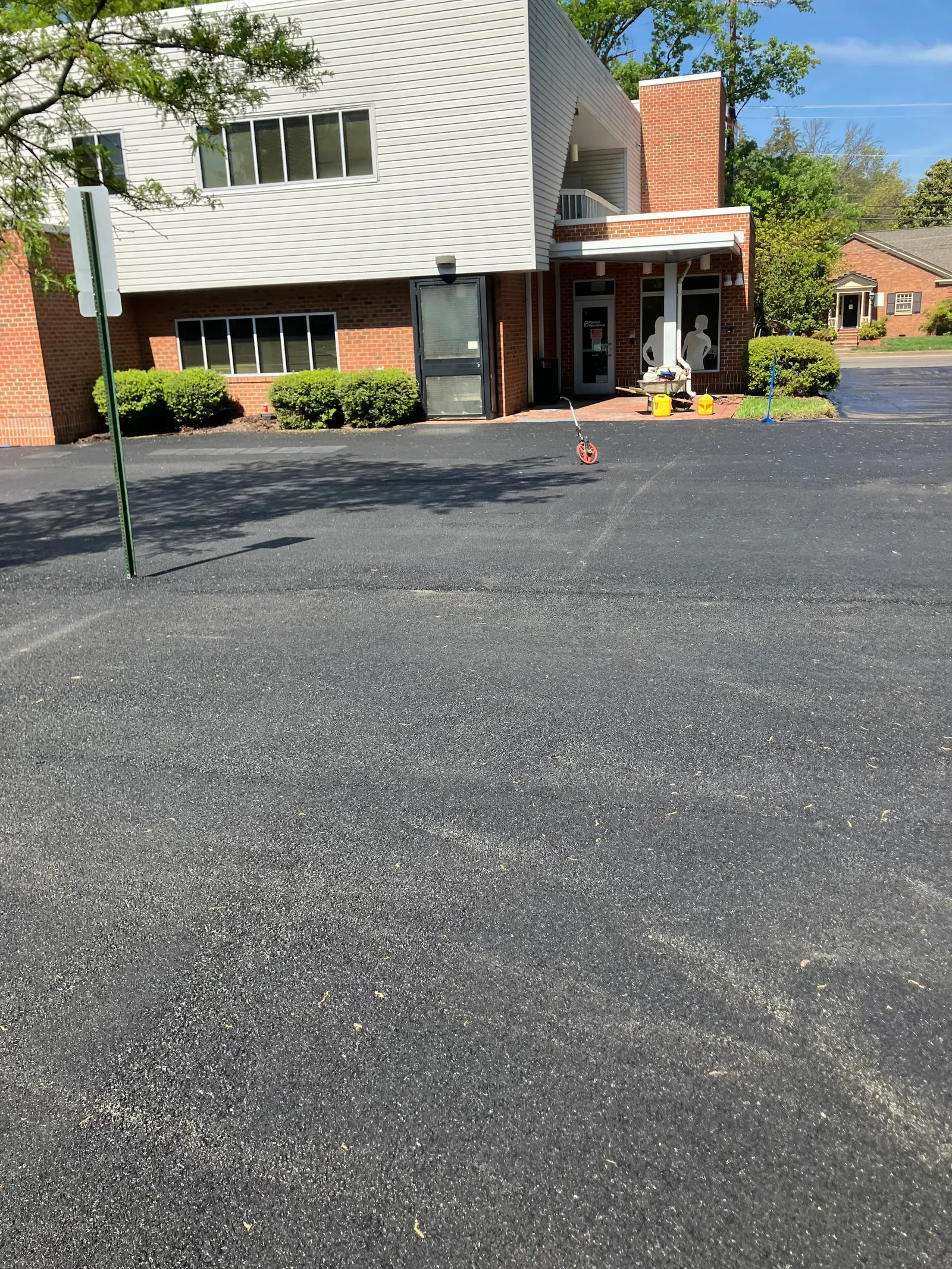 Office lot freshly sealed, measuring wheel still out